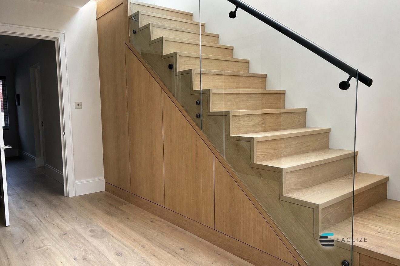 Under-stair storage with full height timber doors cut to the line of the staircase